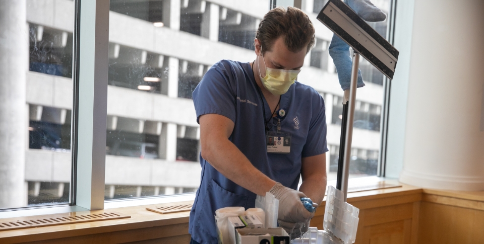 Jesse working in the hospital after Trellis, Inc. helped get him hired by OHSU